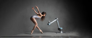 Dr Merritt Moore, physicist and ballerina dances with a robot by Universal Robotic.